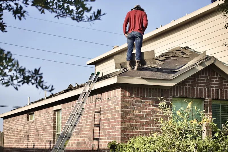 Professional roofer working on a residential roof in Accotink Heights